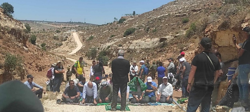 Citizens perform Friday prayers on the lands of Deir Istiya, which are threatened with confiscation