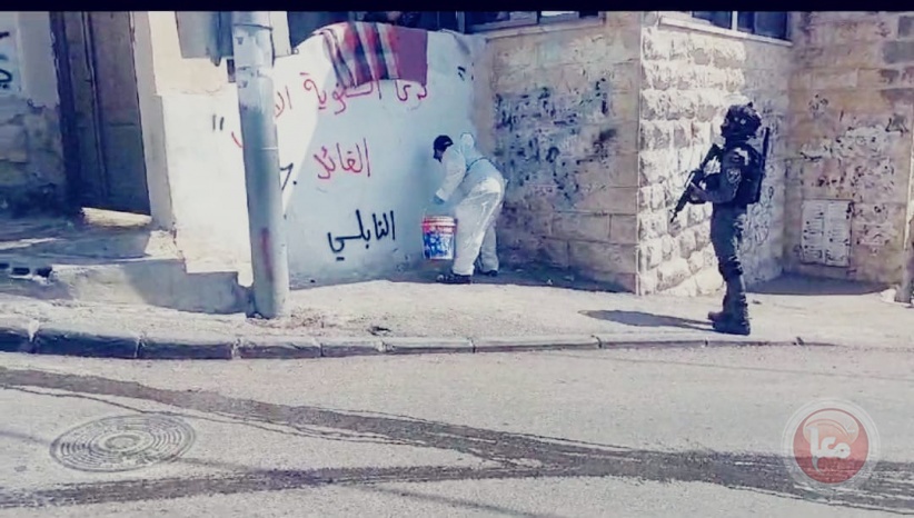 Occupation forces erase national slogans from the walls of Al-Isawiya town