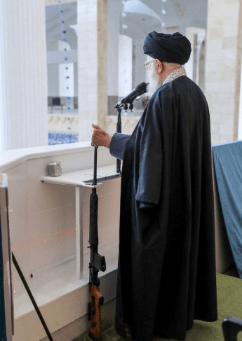 What is the explanation for Khamenei’s appearance leaning on his rifle during the Eid al-Fitr sermon?